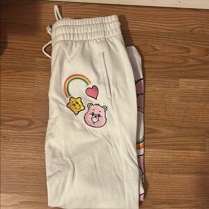 White and Pink Graphic Track Pants with Playful Design